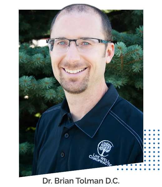 Chiropractor Brian Tolman Smiling Outdoors In Front Of Pine Tree With Attribution